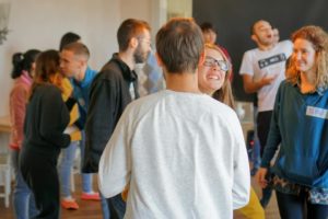 People smiling during a greeting game